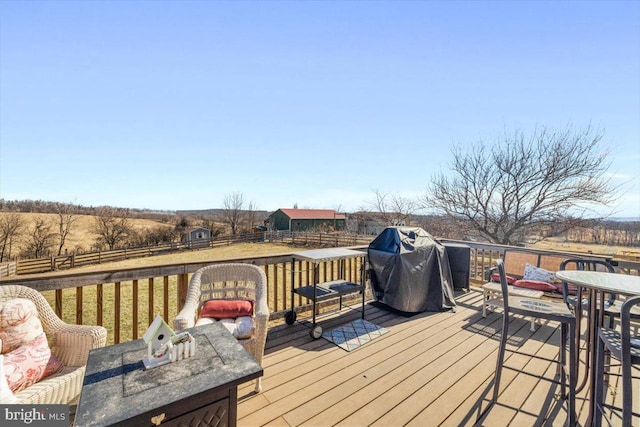 wooden deck with fence, grilling area, and outdoor dining space