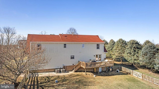 back of house featuring a yard, a wooden deck, and fence