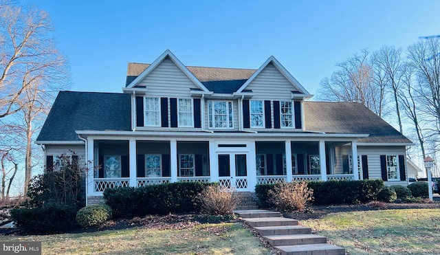 view of front of home with covered porch and roof with shingles