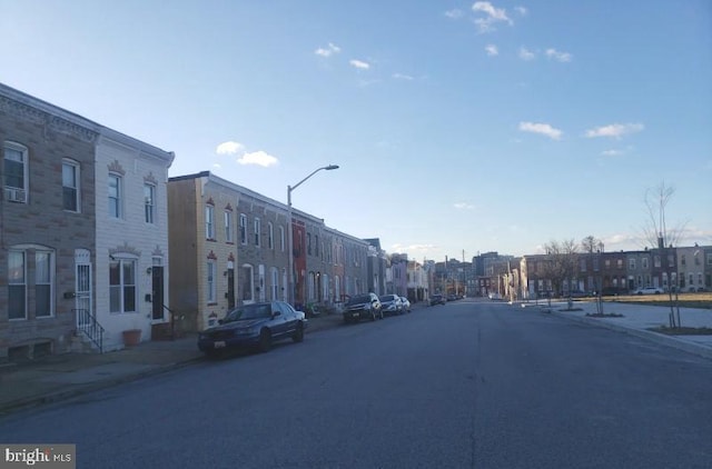 view of street featuring curbs, street lighting, and sidewalks