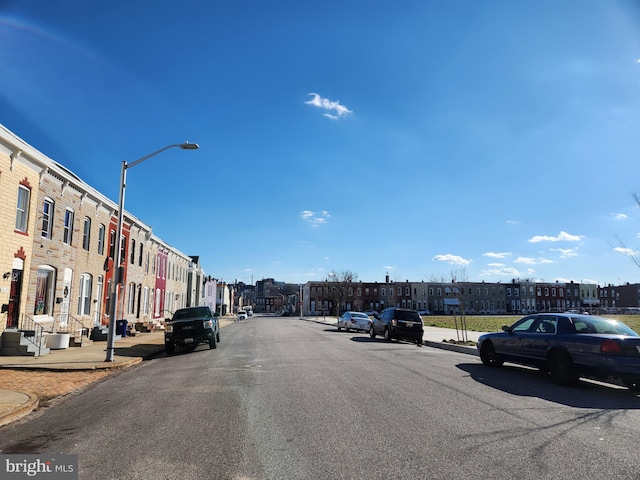 view of street with sidewalks, street lighting, and curbs