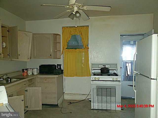 kitchen featuring white appliances, a sink, and a ceiling fan