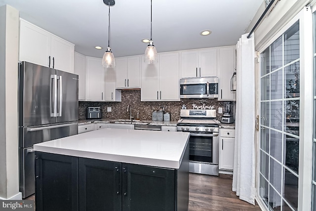 kitchen featuring light countertops, white cabinets, dark wood-style floors, and stainless steel appliances