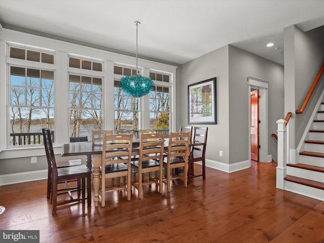 dining space featuring wood-type flooring, baseboards, and plenty of natural light