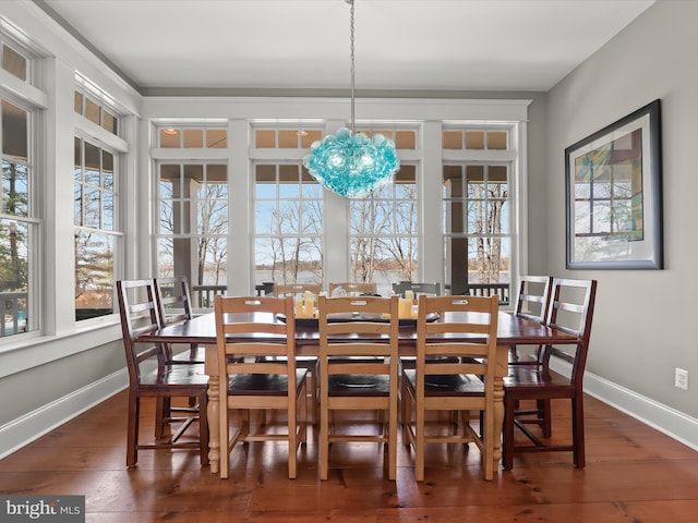 dining space featuring a chandelier, baseboards, plenty of natural light, and hardwood / wood-style floors