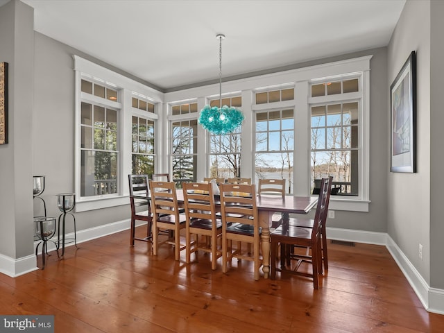 dining space featuring visible vents, baseboards, and hardwood / wood-style floors