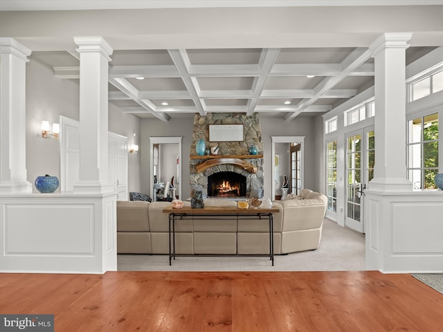 living room featuring coffered ceiling, decorative columns, wood-type flooring, and beam ceiling