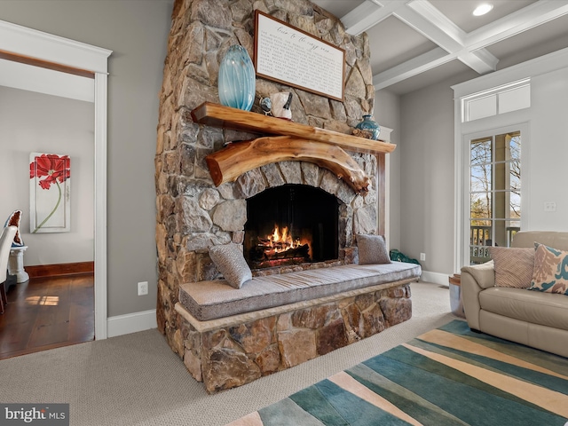 carpeted living room featuring coffered ceiling, beamed ceiling, a fireplace, and baseboards