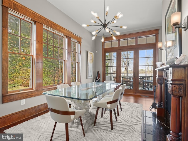 dining room with a notable chandelier and baseboards