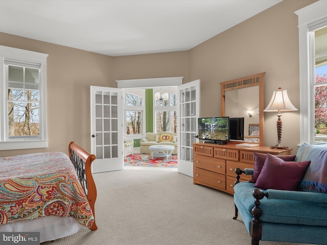carpeted bedroom featuring french doors