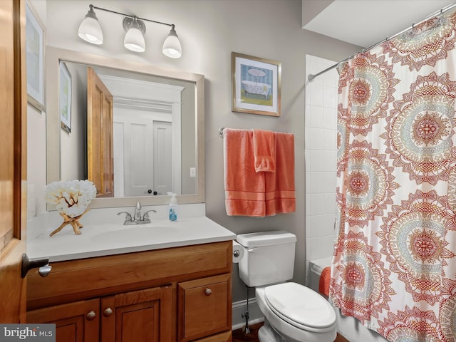 bathroom featuring shower / bath combo, toilet, and vanity
