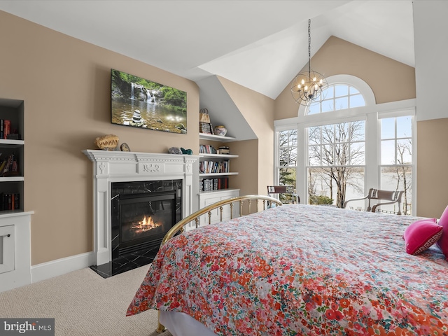 carpeted bedroom with baseboards, a notable chandelier, vaulted ceiling, and a fireplace with flush hearth