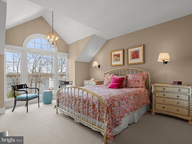 carpeted bedroom featuring an inviting chandelier and vaulted ceiling