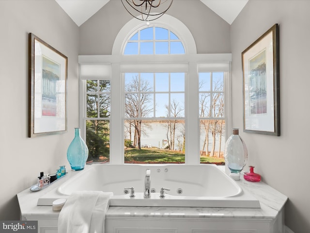 full bathroom with a whirlpool tub, a wealth of natural light, and lofted ceiling
