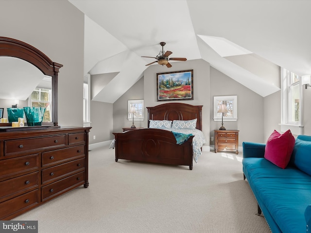 bedroom featuring ceiling fan, light colored carpet, baseboards, and lofted ceiling