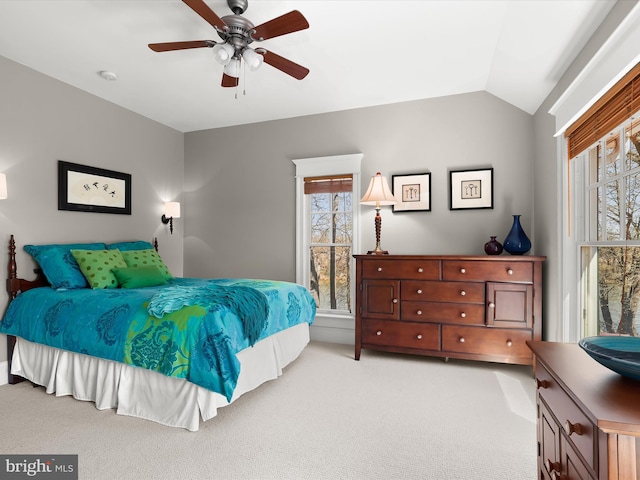 bedroom with light colored carpet, a ceiling fan, and lofted ceiling