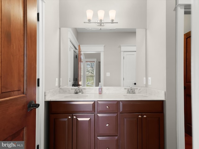 full bathroom with double vanity and a sink