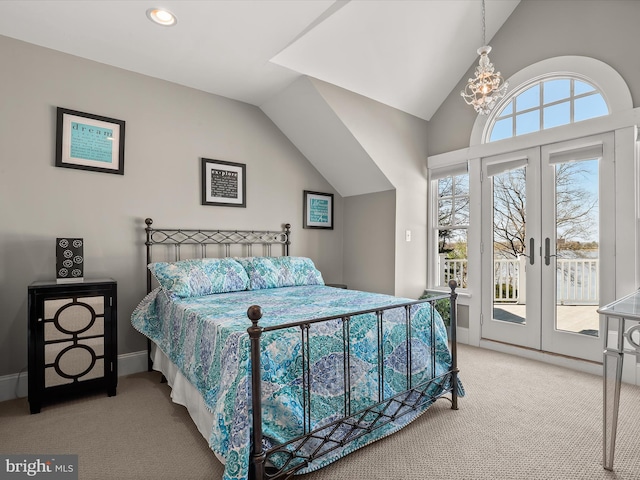 bedroom with a notable chandelier, vaulted ceiling, french doors, access to exterior, and light colored carpet