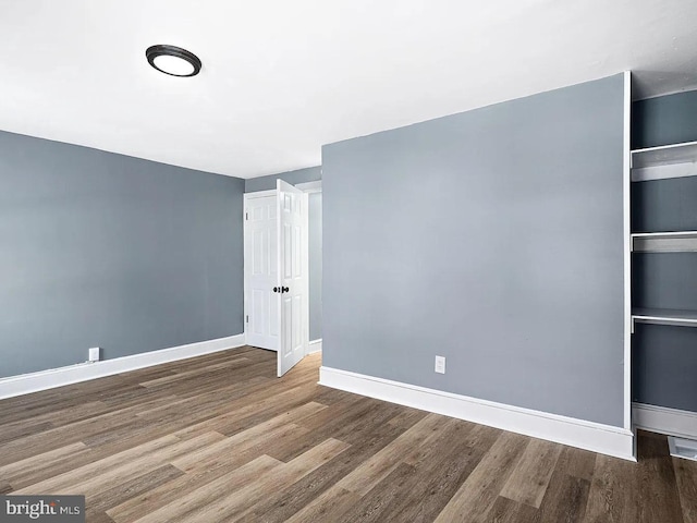 unfurnished bedroom featuring baseboards and wood finished floors