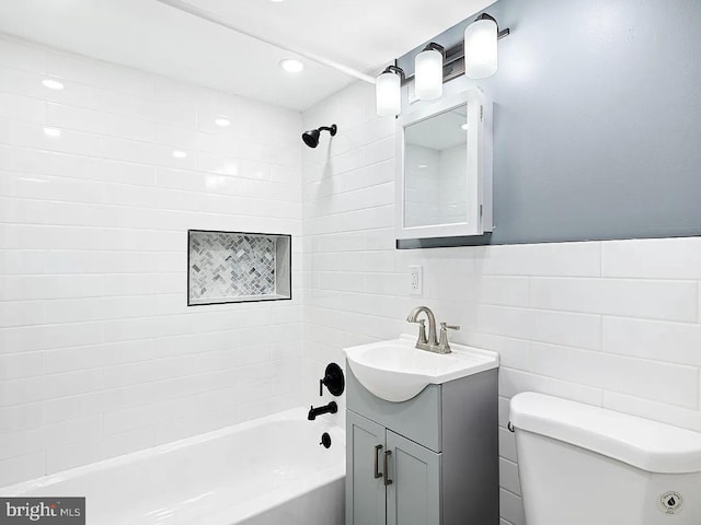 full bathroom featuring tile walls, recessed lighting, shower / bath combination, toilet, and vanity