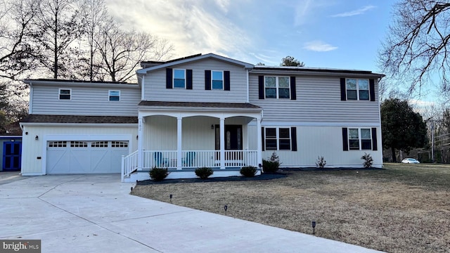 traditional home with a porch, concrete driveway, an attached garage, and roof with shingles