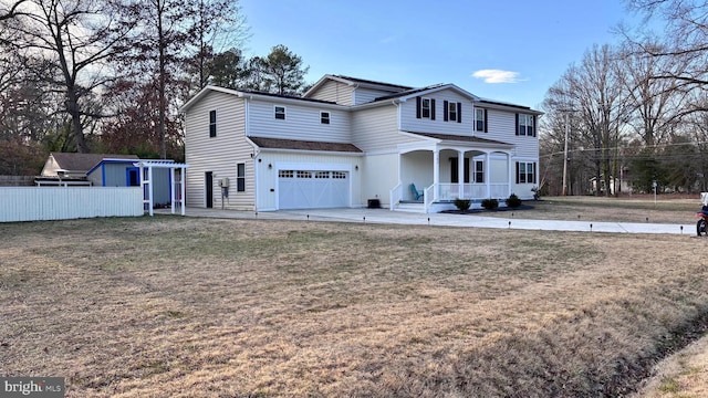 traditional-style home with a garage, covered porch, a front yard, and fence