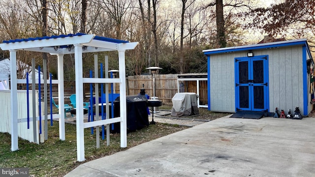 view of shed featuring a playground and fence