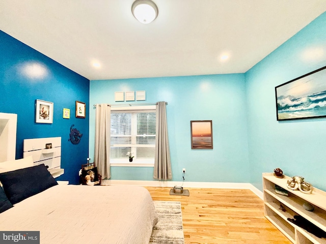 bedroom with recessed lighting, baseboards, and wood finished floors