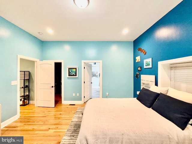 bedroom featuring recessed lighting, baseboards, and light wood-style floors