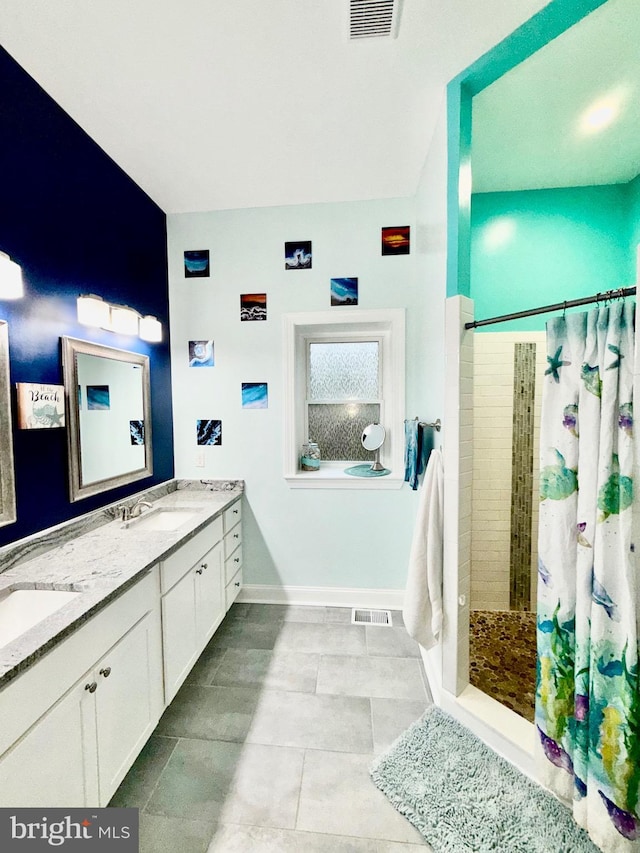 bathroom with a sink, visible vents, and tiled shower