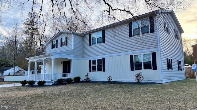 view of front facade with covered porch and a front lawn