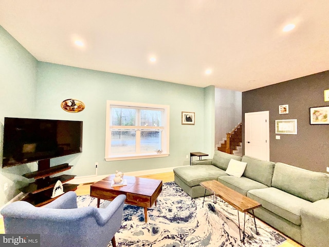 living room with recessed lighting, stairway, baseboards, and wood finished floors