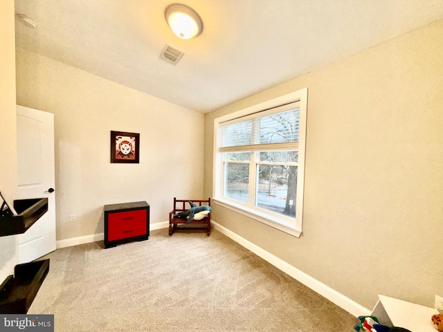 sitting room with vaulted ceiling, visible vents, baseboards, and carpet floors