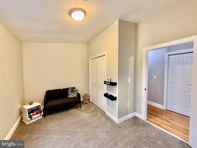 sitting room featuring baseboards and carpet