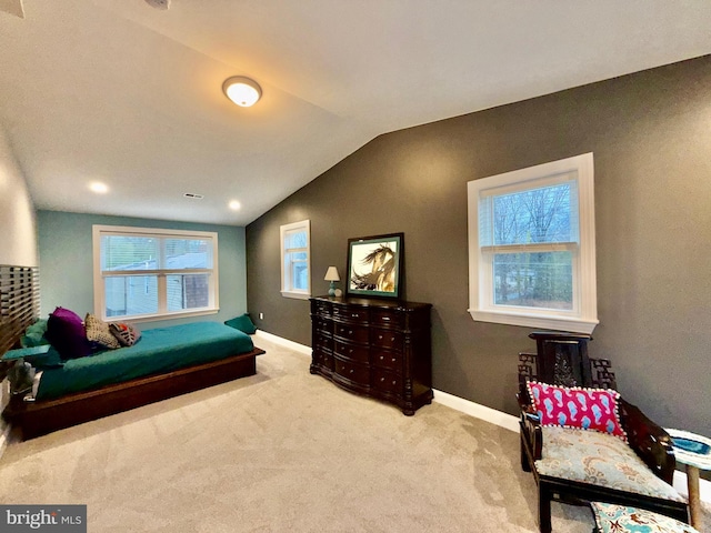 carpeted bedroom featuring visible vents, baseboards, and lofted ceiling