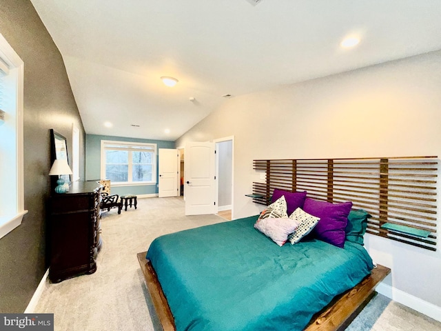 carpeted bedroom with baseboards and lofted ceiling