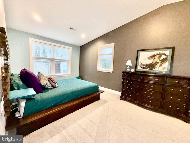 carpeted bedroom with visible vents, baseboards, and vaulted ceiling