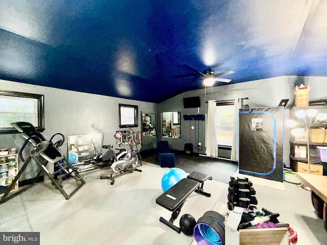 workout room featuring a wealth of natural light, ceiling fan, and vaulted ceiling