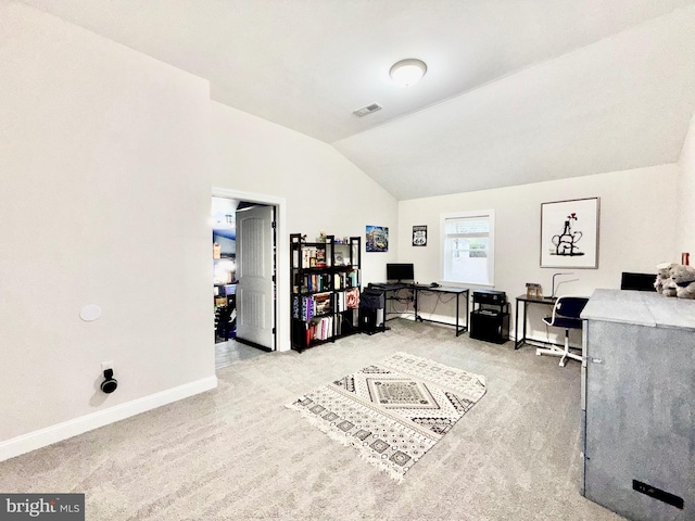 office space featuring vaulted ceiling, baseboards, and light carpet