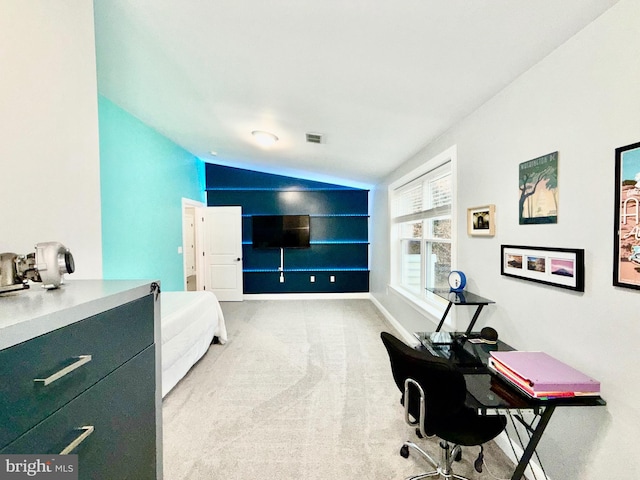 office area featuring light carpet, visible vents, baseboards, and vaulted ceiling