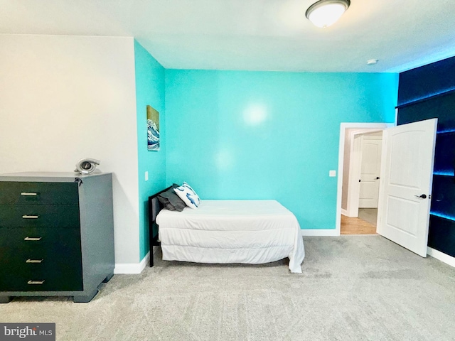 carpeted bedroom featuring baseboards