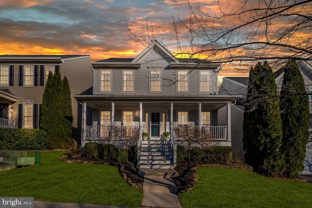 view of front of property with a porch and a front lawn