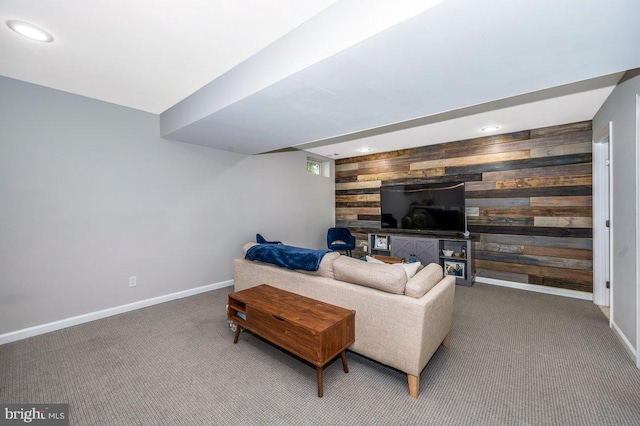 carpeted living room with an accent wall, recessed lighting, wood walls, and baseboards