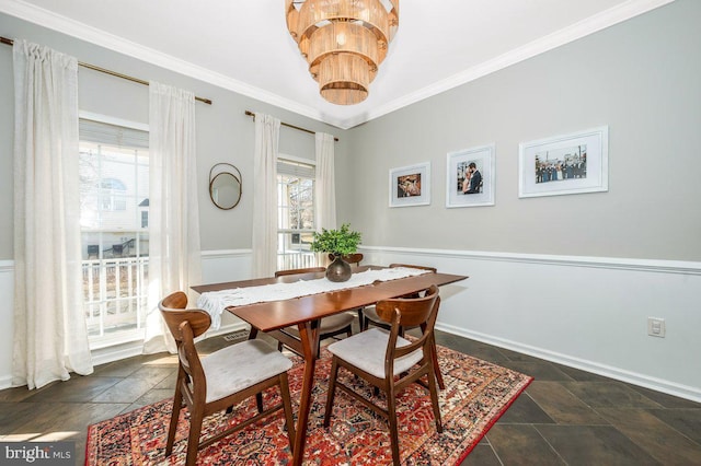 dining area featuring a healthy amount of sunlight, stone tile flooring, and crown molding