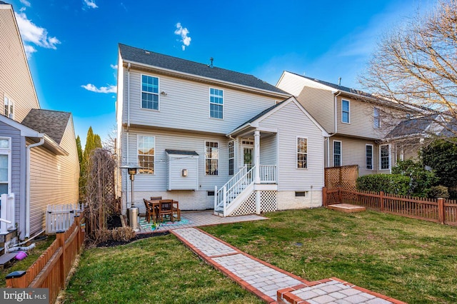 rear view of property with a patio area, a fenced backyard, a lawn, and crawl space