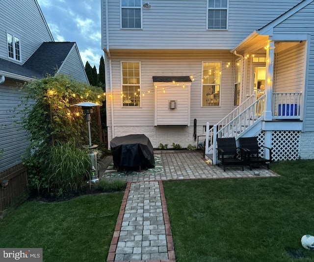 rear view of property with a patio area and a yard