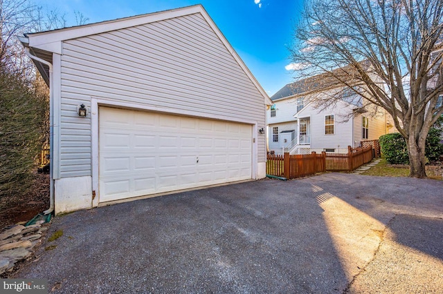 detached garage featuring fence