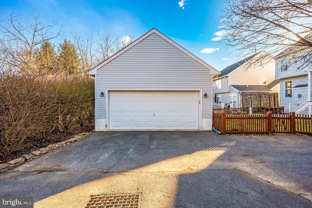 detached garage featuring fence