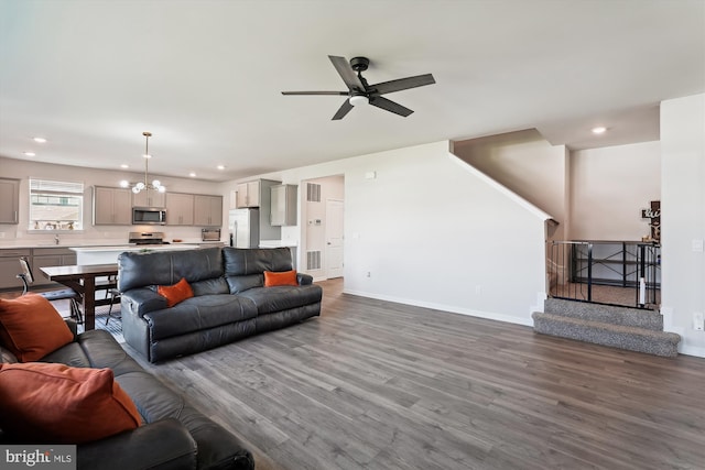 348 Tyson Dr, Berryville, VA 22611 - living area with wood finished floors, a chandelier, a ceiling fan, stairway, and baseboards