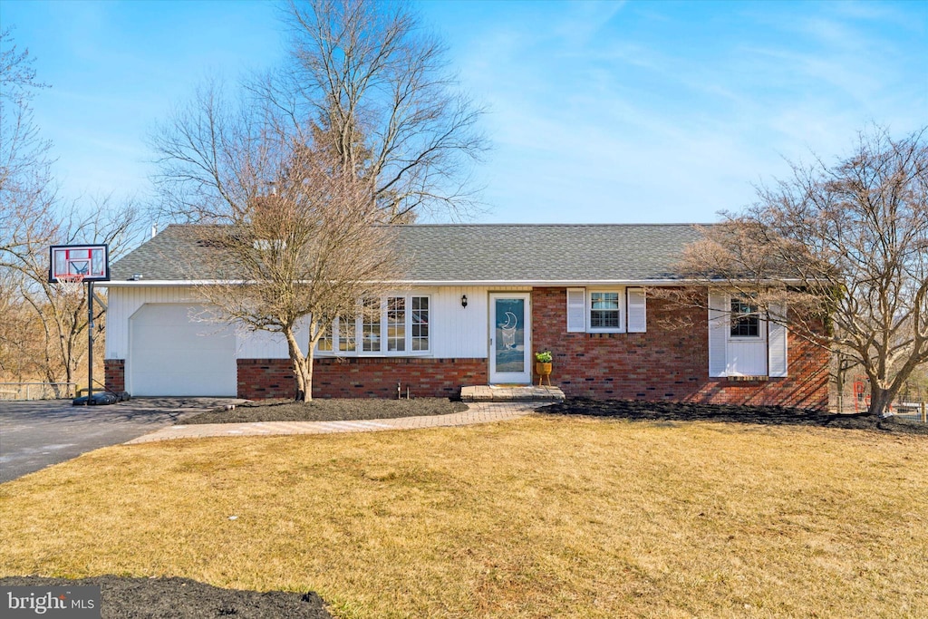 single story home featuring driveway, roof with shingles, an attached garage, a front lawn, and brick siding